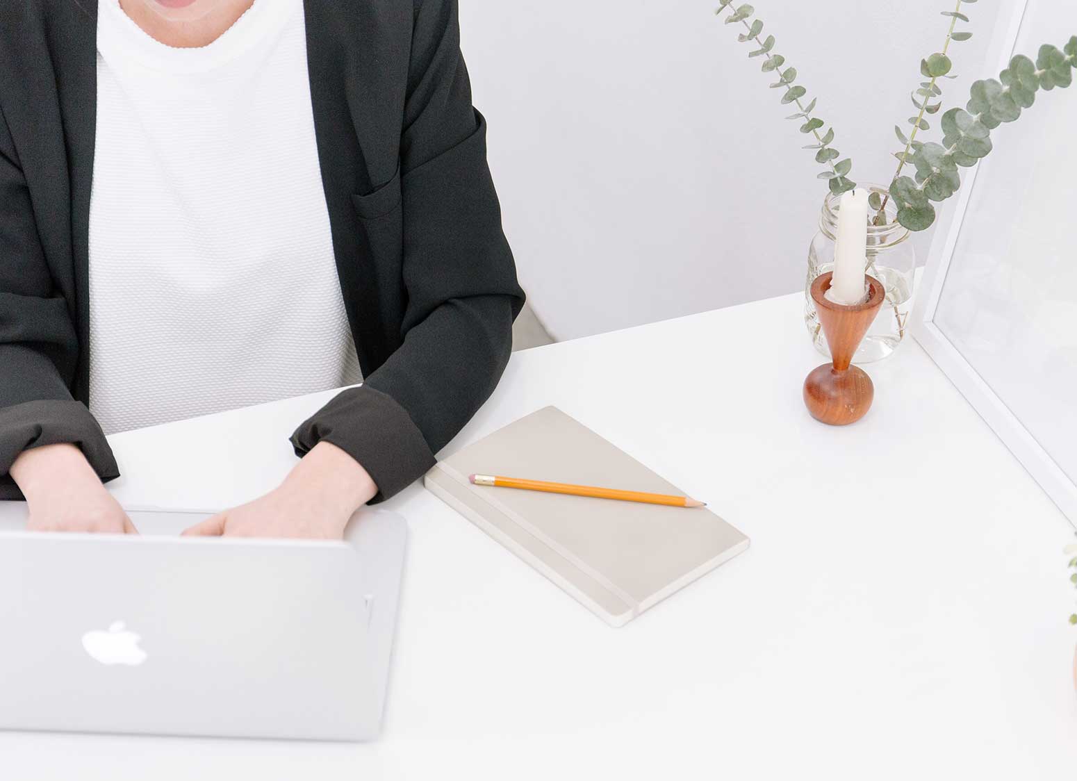 Woman typing on laptop at desk