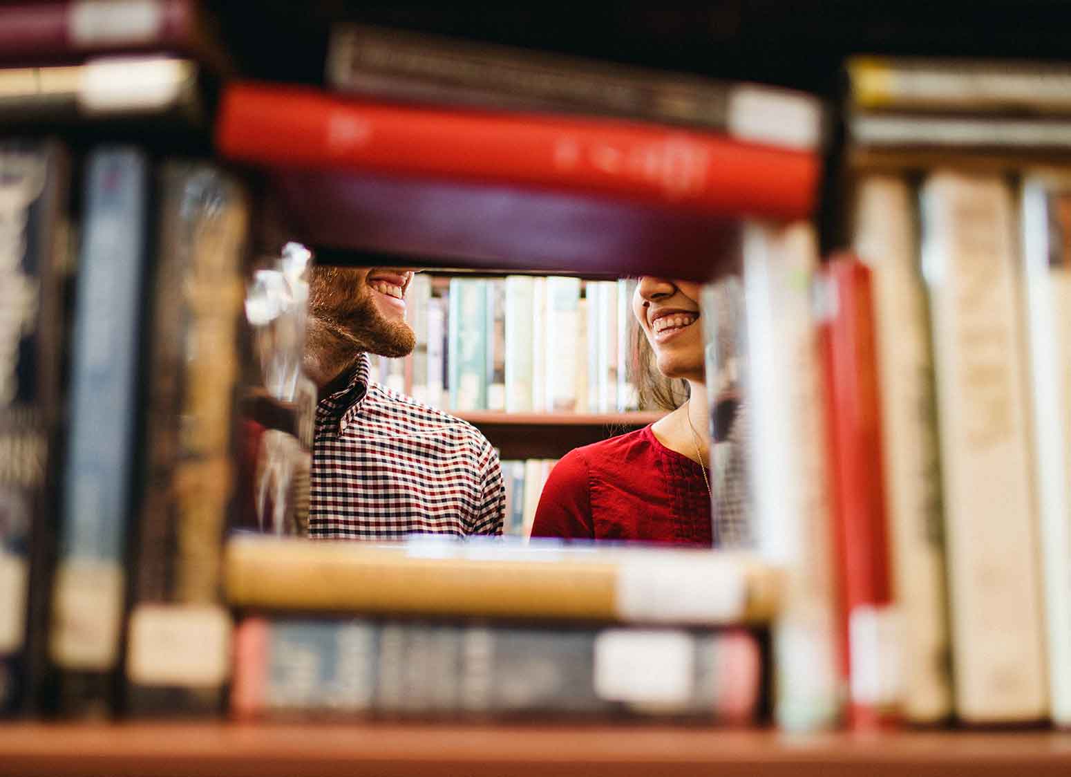 library visitors framed by books on shelf