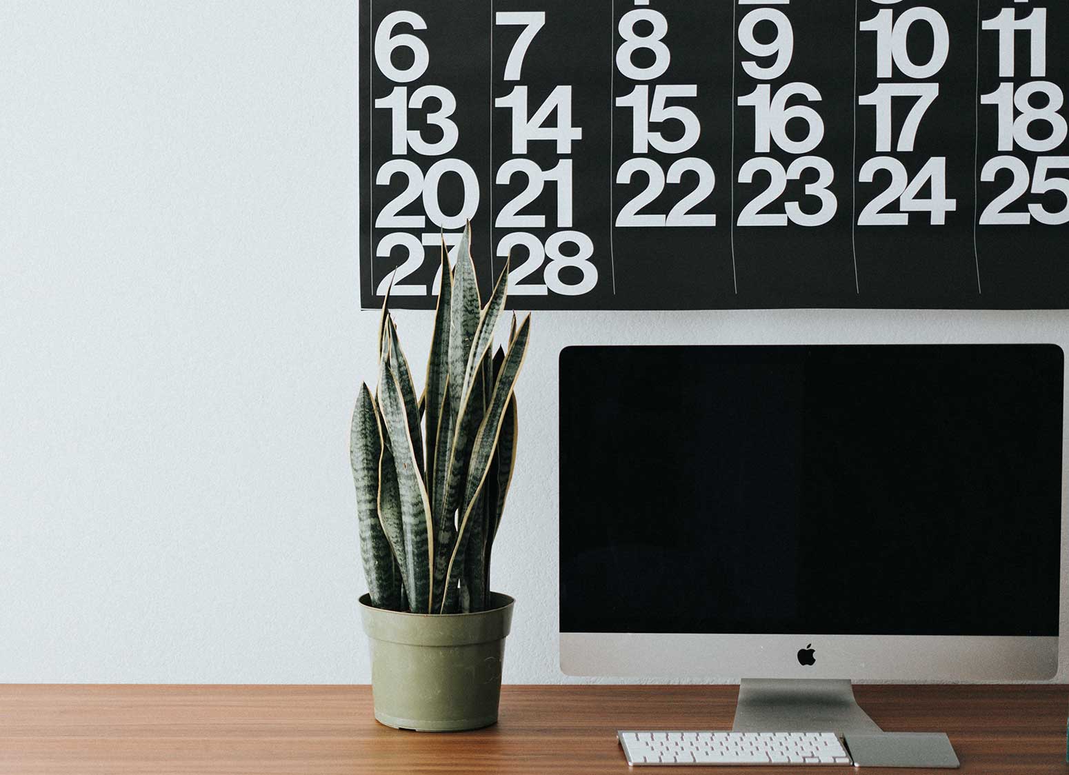 desktop computer with calendar in background