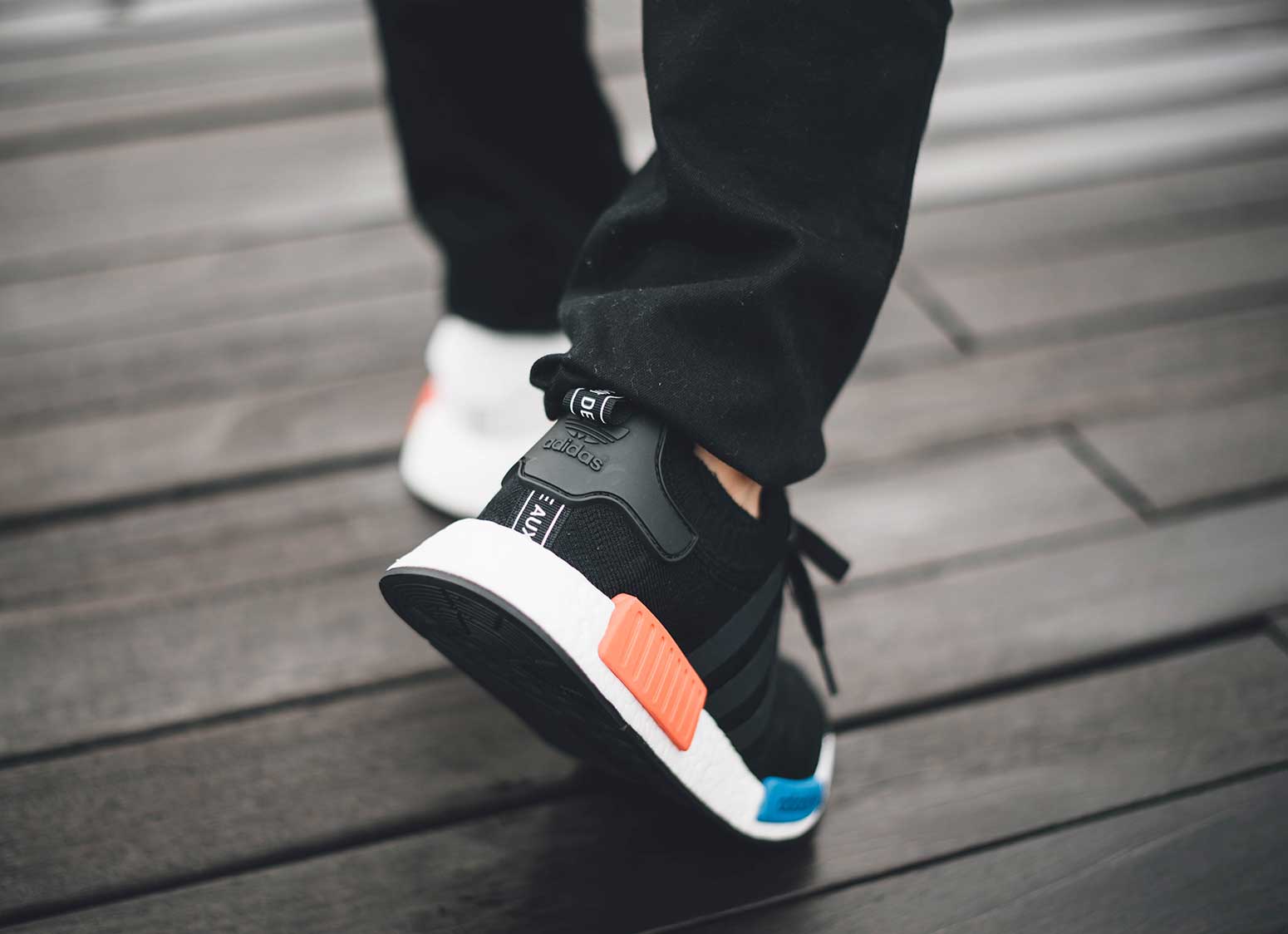 closeup of man in sneakers walking away