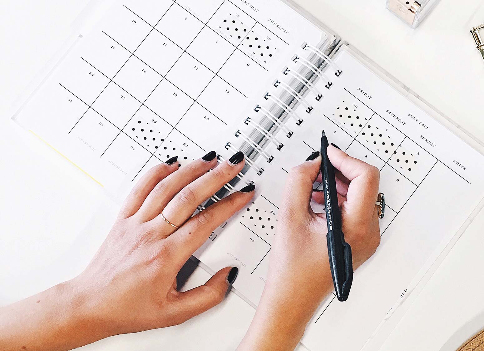 woman's hands writing agenda