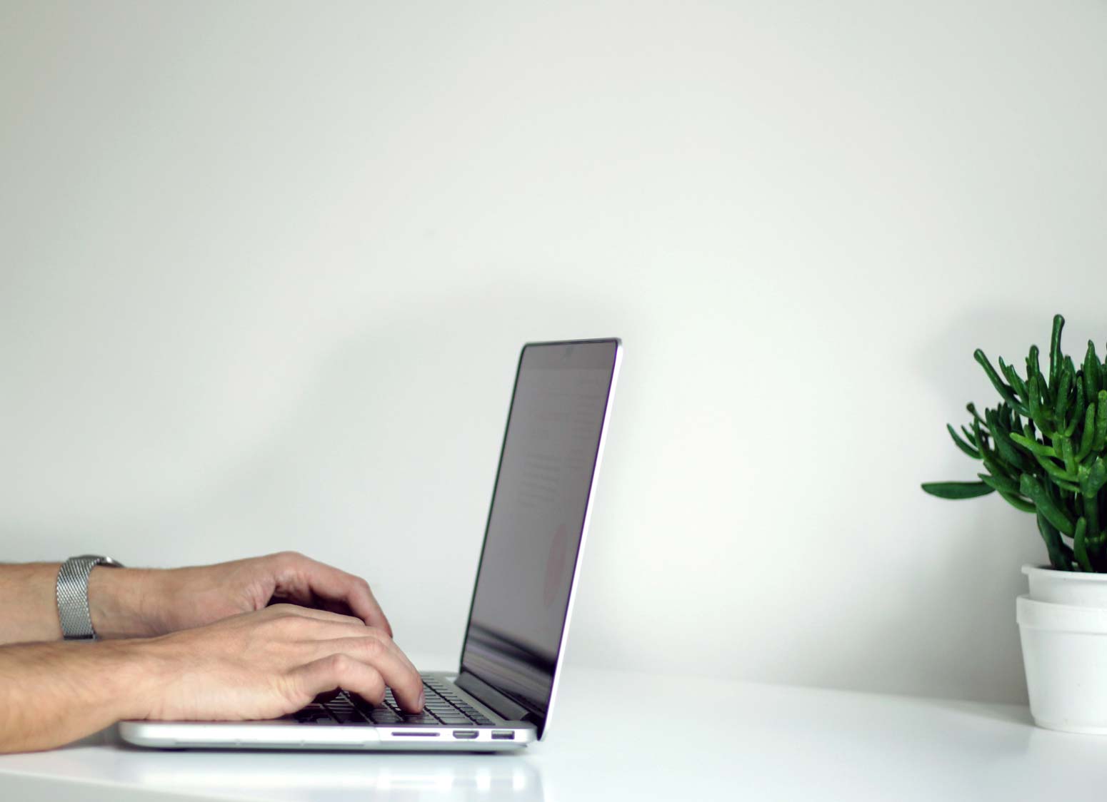 man typing on laptop